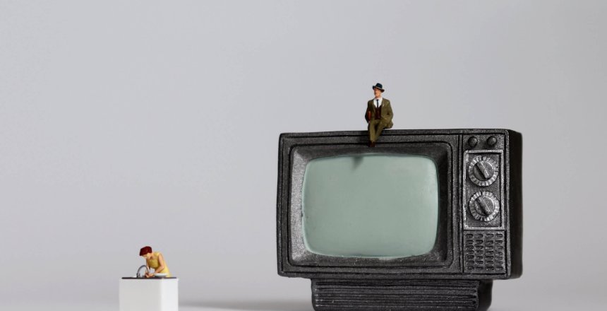 Miniature,Man,Sitting,On,Miniature,Television,And,A,Miniature,Woman